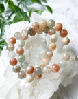 ARUSHA SUNSTONE MOONSTONE 10mm - HANDMADE CRYSTAL BRACELET - 10mm, abundance gift bundle, Arusha sunstone, bracelet, career, crystal bracelet, fertility, fire, grey, handmade bracelet, jewelry, joy gift bundle, june wrist candy, Leo, leo stack, libra, libra stack, market bracelet, new beginnings gift bundle, orange, recently added, restocked, solar eclipse, summer solstice, summer wrist candy, sunstone, Tanzanian sunstone, Wearable - The Mineral Maven