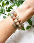 ARUSHA SUNSTONE MOONSTONE 10mm - HANDMADE CRYSTAL BRACELET - 10mm, abundance gift bundle, Arusha sunstone, bracelet, career, crystal bracelet, fertility, fire, grey, handmade bracelet, jewelry, joy gift bundle, june wrist candy, Leo, leo stack, libra, libra stack, market bracelet, new beginnings gift bundle, orange, recently added, restocked, solar eclipse, summer solstice, summer wrist candy, sunstone, Tanzanian sunstone, Wearable - The Mineral Maven