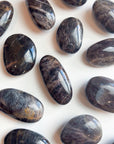 BLACK MOONSTONE PEBBLE - 2025 vibes, Black Friday sale, black moonstone, bulk, creativity, fertility, grounding, moonstone, new beginnings, new beginnings gift bundle, palm stone, pebble, pebbles, pocket crystal, protection, protection gift bundle, solar eclipse, spring equinox, spring things, taurus, taurus season, tumble - The Mineral Maven
