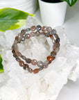 BLACK SUNSTONE (FACETED COIN) 8mm - HANDMADE CRYSTAL BRACELET - 10 Dec Inventory, 8mm, black sunstone, bracelet, career, crystal bracelet, faceted, faceted coin, fire, handmade bracelet, jewelry, June 2025 inventory check, Leo, Leo szn, libra, market bracelet, memento mori, memento mori collection, orange, sunstone, Wearable - The Mineral Maven