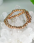 ROSE GOLD TITANIUM COATED HEMATITE (FACETED) 6mm - HANDMADE CRYSTAL BRACELET - 10 Dec Inventory, 6mm, bracelet, bracelet inventory check, crystal bracelet, faceted, handmade bracelet, hematite, jewelry, June 2025 inventory check, rose gold, titanium coated, valentines bracelets, valentines vibes, Wearable - The Mineral Maven