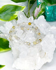 RUTILATED QUARTZ (FACETED) 6mm - HANDMADE CRYSTAL BRACELET - 10 Dec Inventory, 6mm, bracelet, bracelet inventory check, clear/white, crystal bracelet, emotional support, faceted, fall-o-ween, fall-o-ween bracelets, focus gift bundle, gemini, gemini stack, handmade bracelet, jewelry, June 2025 inventory check, leo, leo stack, market bracelet, metallic, rutilated quartz, storm, Wearable, yellow - The Mineral Maven