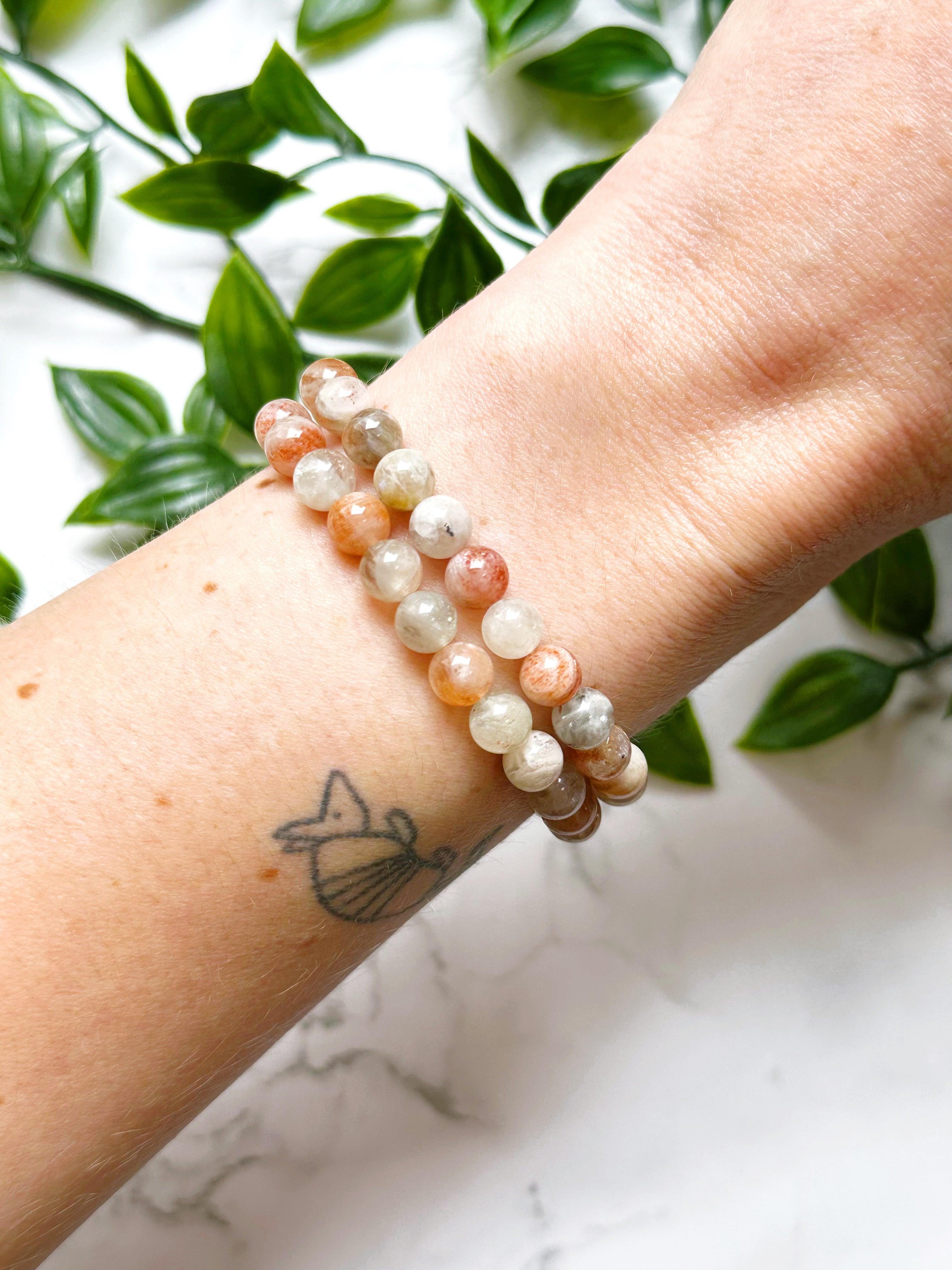 ARUSHA SUNSTONE MOONSTONE 7mm - HANDMADE CRYSTAL BRACELET - 7mm, abundance gift bundle, Arusha sunstone, bracelet, career, crystal bracelet, fertility, fire, grey, handmade bracelet, jewelry, joy gift bundle, june wrist candy, Leo, leo stack, libra, libra stack, market bracelet, new beginnings gift bundle, orange, recently added, restocked, solar eclipse, summer solstice, summer wrist candy, sunstone, Tanzanian sunstone, Wearable - The Mineral Maven