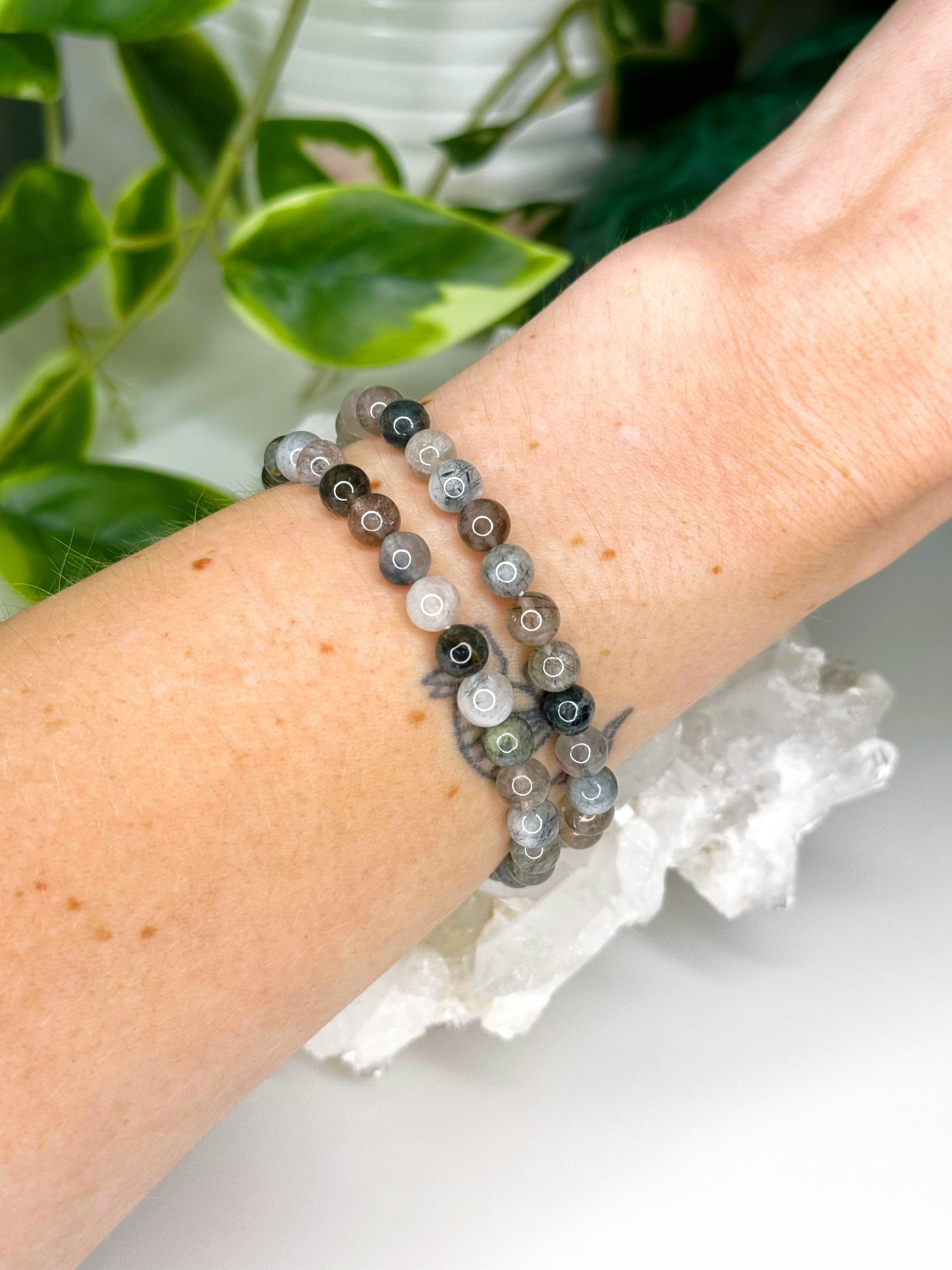 GREY RUTILATED QUARTZ 6mm - HANDMADE CRYSTAL BRACELET - 10 Dec Inventory, 6mm, bracelet, bracelet inventory check, crystal bracelet, emotional support, focus gift bundle, grey, handmade bracelet, jewelry, June 2025 inventory check, market bracelet, rutilated, rutilated quartz, rutile, Scorpio Season, Wearable - The Mineral Maven