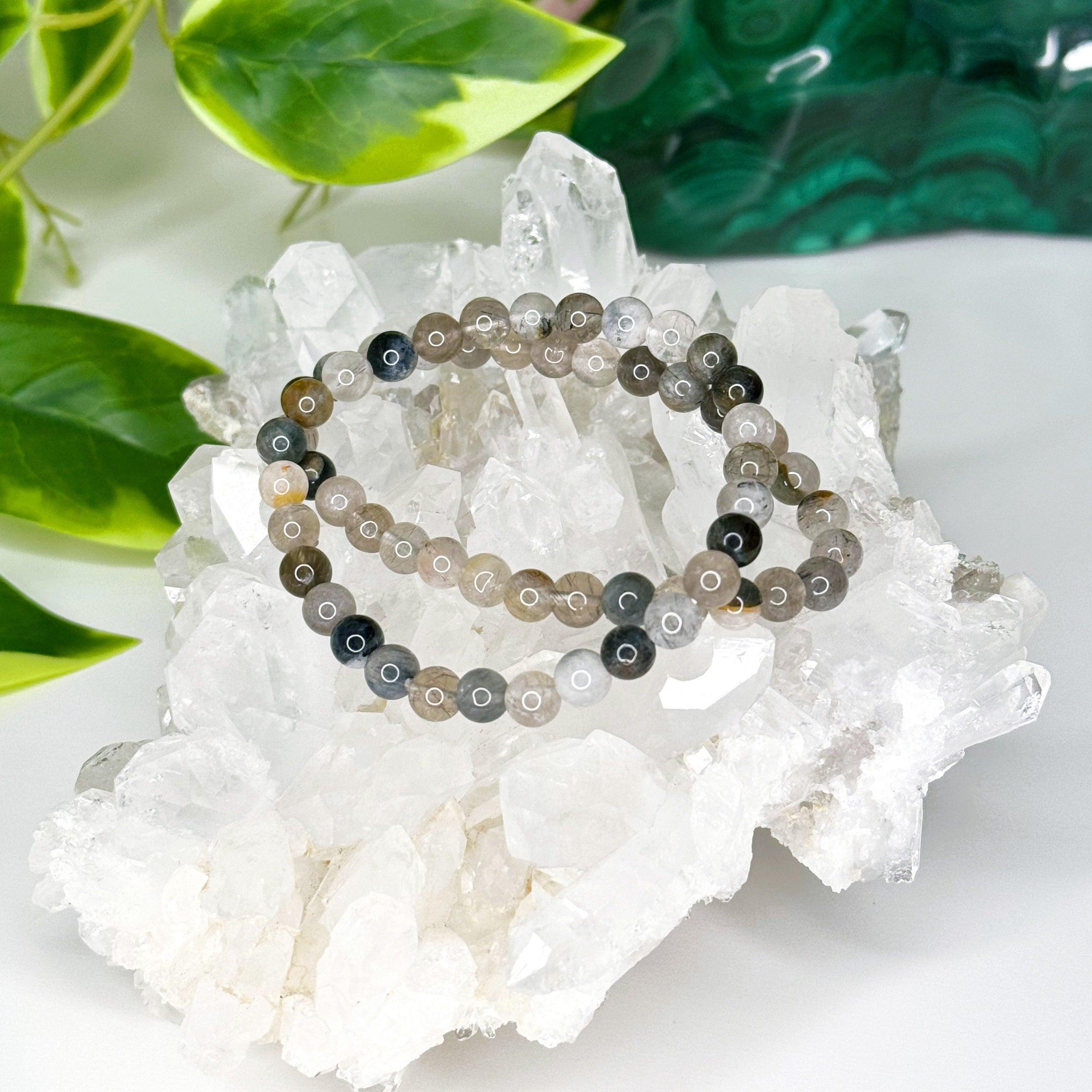 GREY RUTILATED QUARTZ 6mm - HANDMADE CRYSTAL BRACELET - 10 Dec Inventory, 6mm, bracelet, bracelet inventory check, crystal bracelet, emotional support, focus gift bundle, grey, handmade bracelet, jewelry, June 2025 inventory check, market bracelet, rutilated, rutilated quartz, rutile, Scorpio Season, Wearable - The Mineral Maven