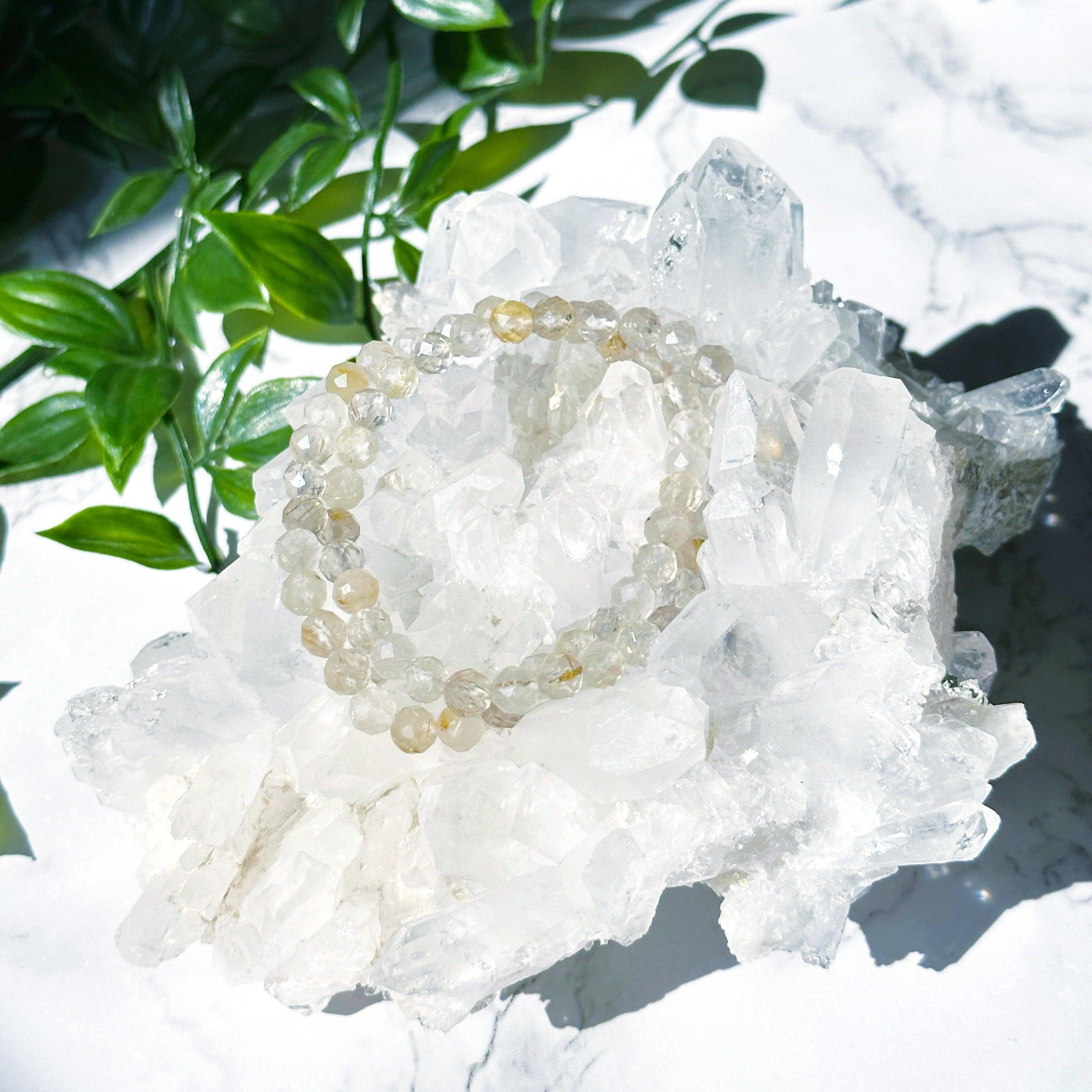 RUTILATED QUARTZ (FACETED) 6mm - HANDMADE CRYSTAL BRACELET - 10 Dec Inventory, 6mm, bracelet, bracelet inventory check, clear/white, crystal bracelet, emotional support, faceted, fall-o-ween, fall-o-ween bracelets, focus gift bundle, gemini, gemini stack, handmade bracelet, jewelry, June 2025 inventory check, leo, leo stack, market bracelet, metallic, rutilated quartz, storm, Wearable, yellow - The Mineral Maven