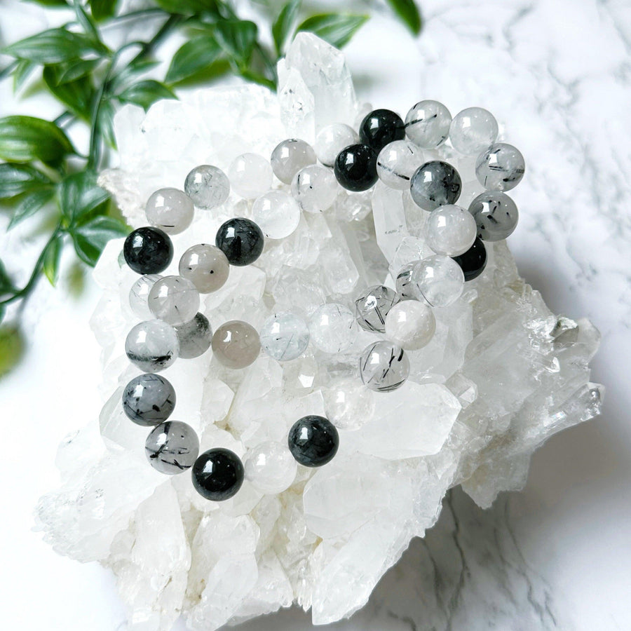 TOURMALINATED QUARTZ 10mm - HANDMADE CRYSTAL BRACELET - 10mm, Aquarius, Aries, black, bracelet, cancer, capricorn, crystal bracelet, earth, gemini, handmade bracelet, jewelry, june wrist candy, Leo, libra, pisces, quartz, recently added, restocked, sagittarius, scorpio, storm, summer solstice, summer wrist candy, taurus, tourmalinated quartz, tourmaline, tourmaline in quartz, virgo, Wearable, white - The Mineral Maven